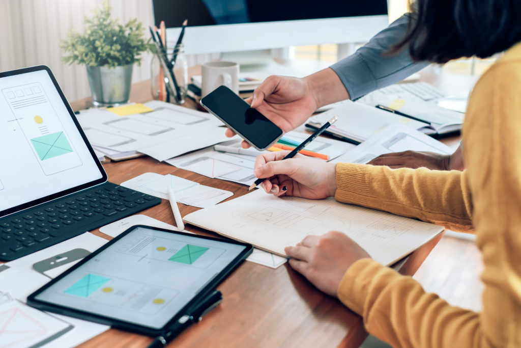 Teamwork process, Young designers planning work together on website ux app development.